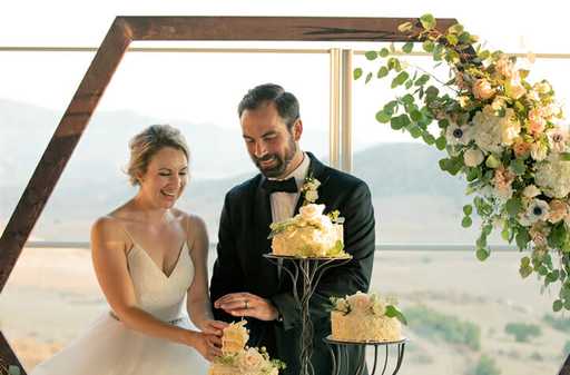 Newly married couple cutting cake at their Jamul Casino wedding at The Rooftop.