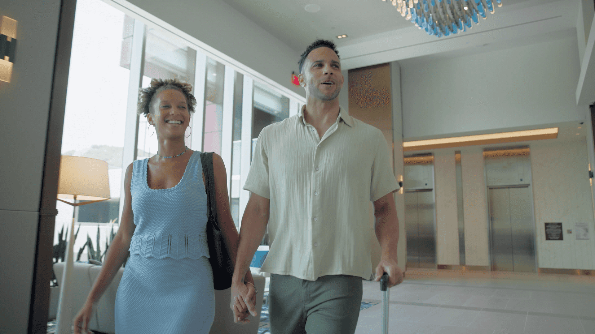 A couple holding hands, walking into Jamul Casino Resort hotel lobby