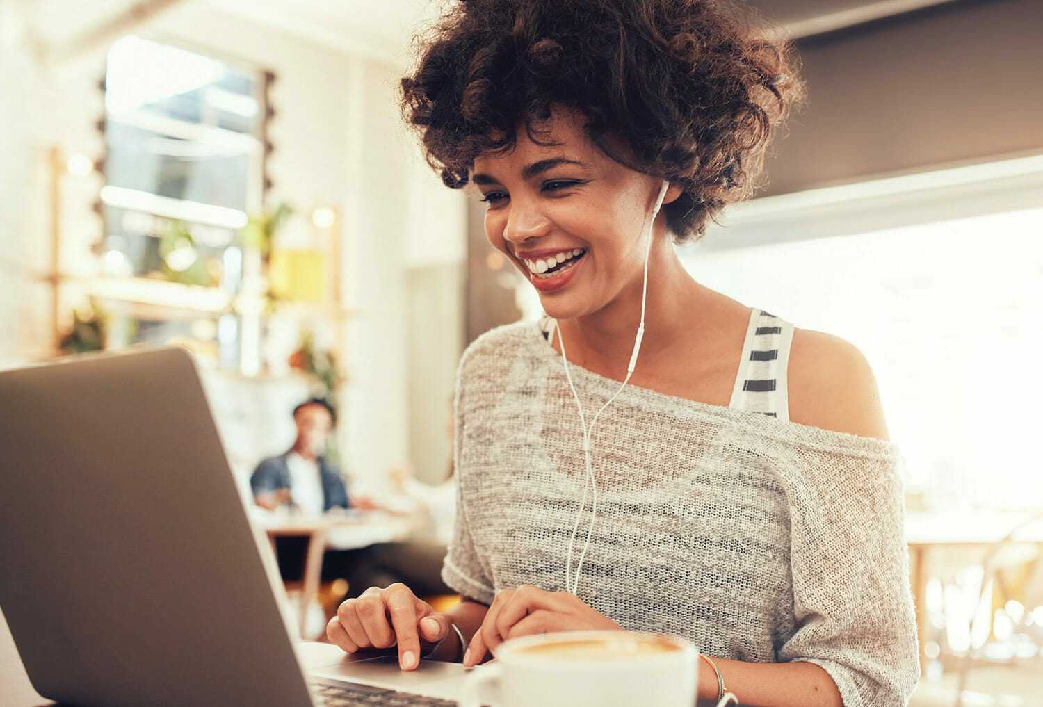 A young lady looking at a laptop.