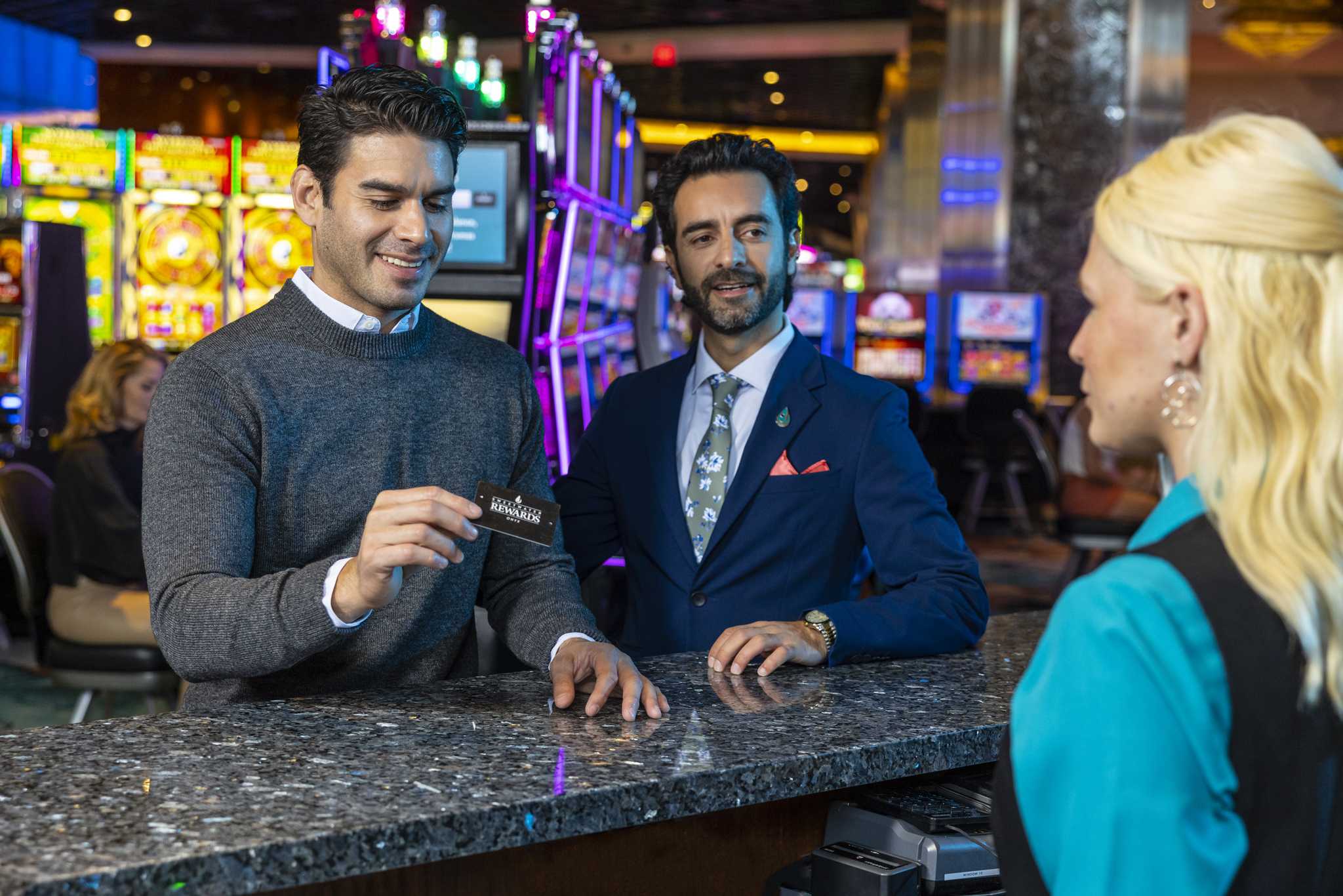 A man receiving a Sweetwater Rewards card at Jamul Casino.