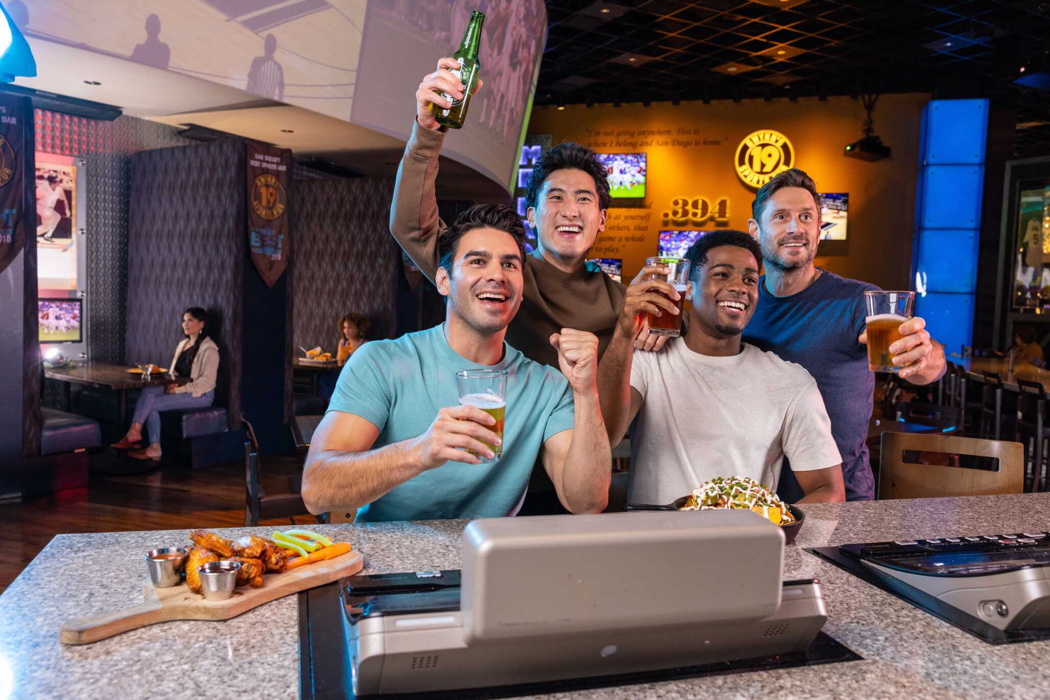 Friends enjoy a game at Tony Gwynn’s Sports Pub.