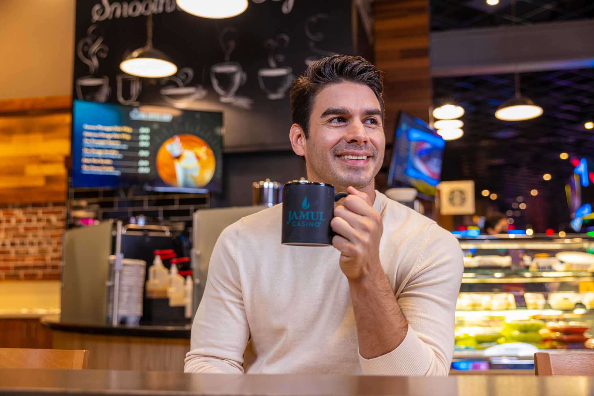 A young man having a cup of coffee.